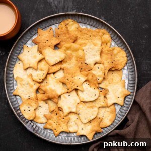 Air Fryer papdi served on a plate with chai on the side, perfect for tea-time