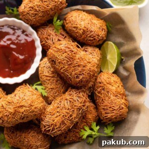 Veg Cutlets served in a blue bowl with green chutney and ketchup on the side