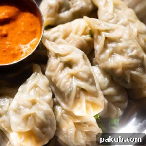 An image of veg momos served with a flavorful dipping chutney