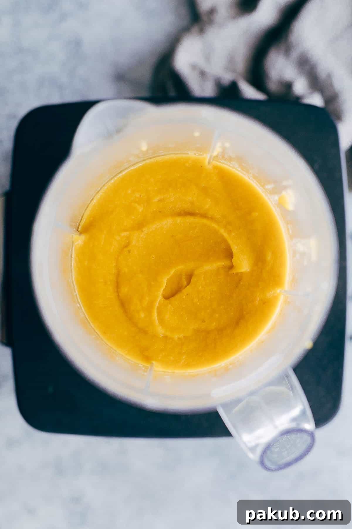 Creamy Thai Butternut Sweet Potato Bisque 3 Close-up of the rich, thick texture of Thai Butternut Squash Sweet Potato Bisque, showing its creamy consistency and inviting color.