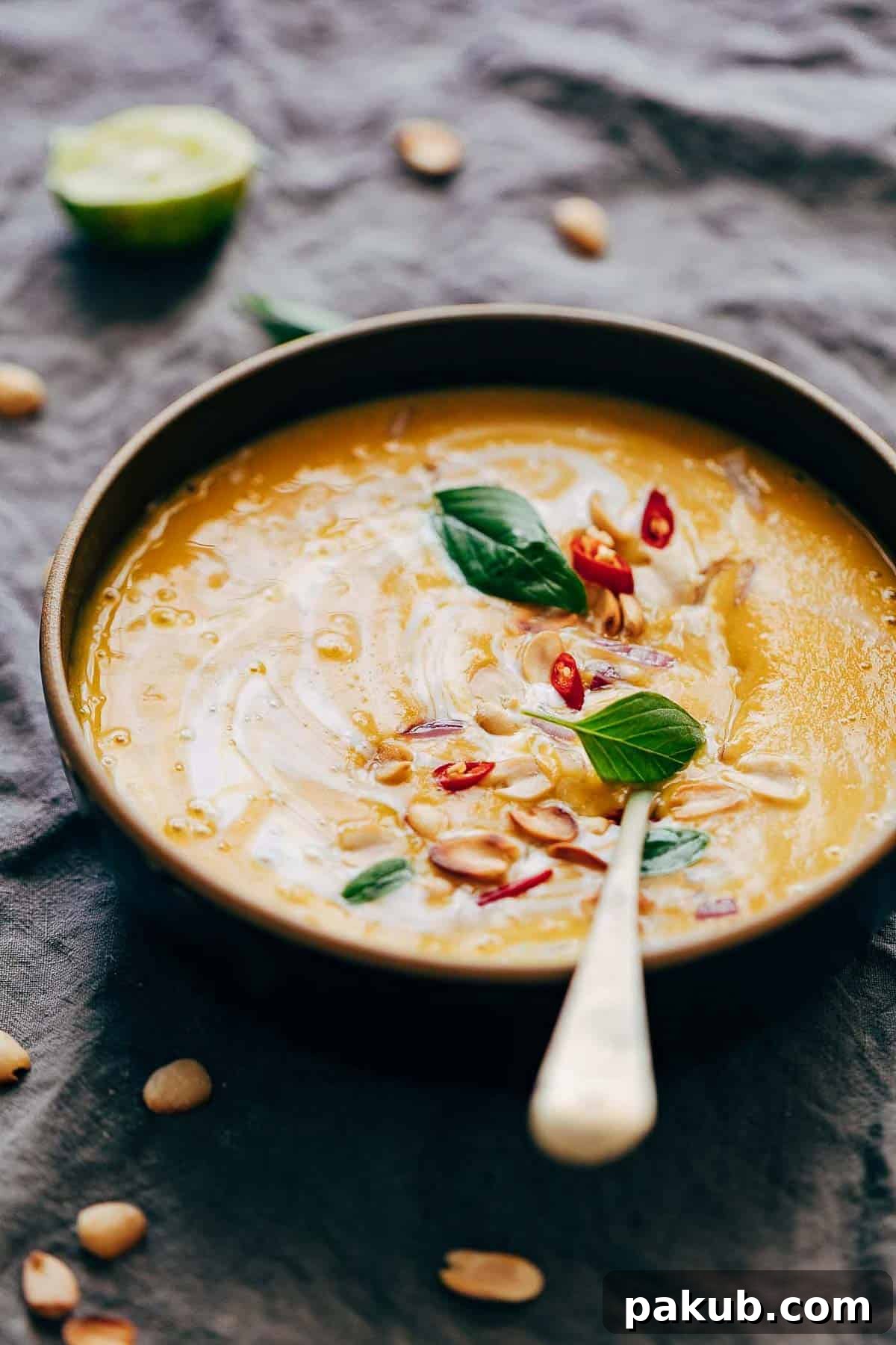 Creamy Thai Butternut Sweet Potato Bisque 4 Ingredients for Thai Butternut Squash Sweet Potato Bisque simmering in a pot, showing the vibrant vegetables and creamy liquid.