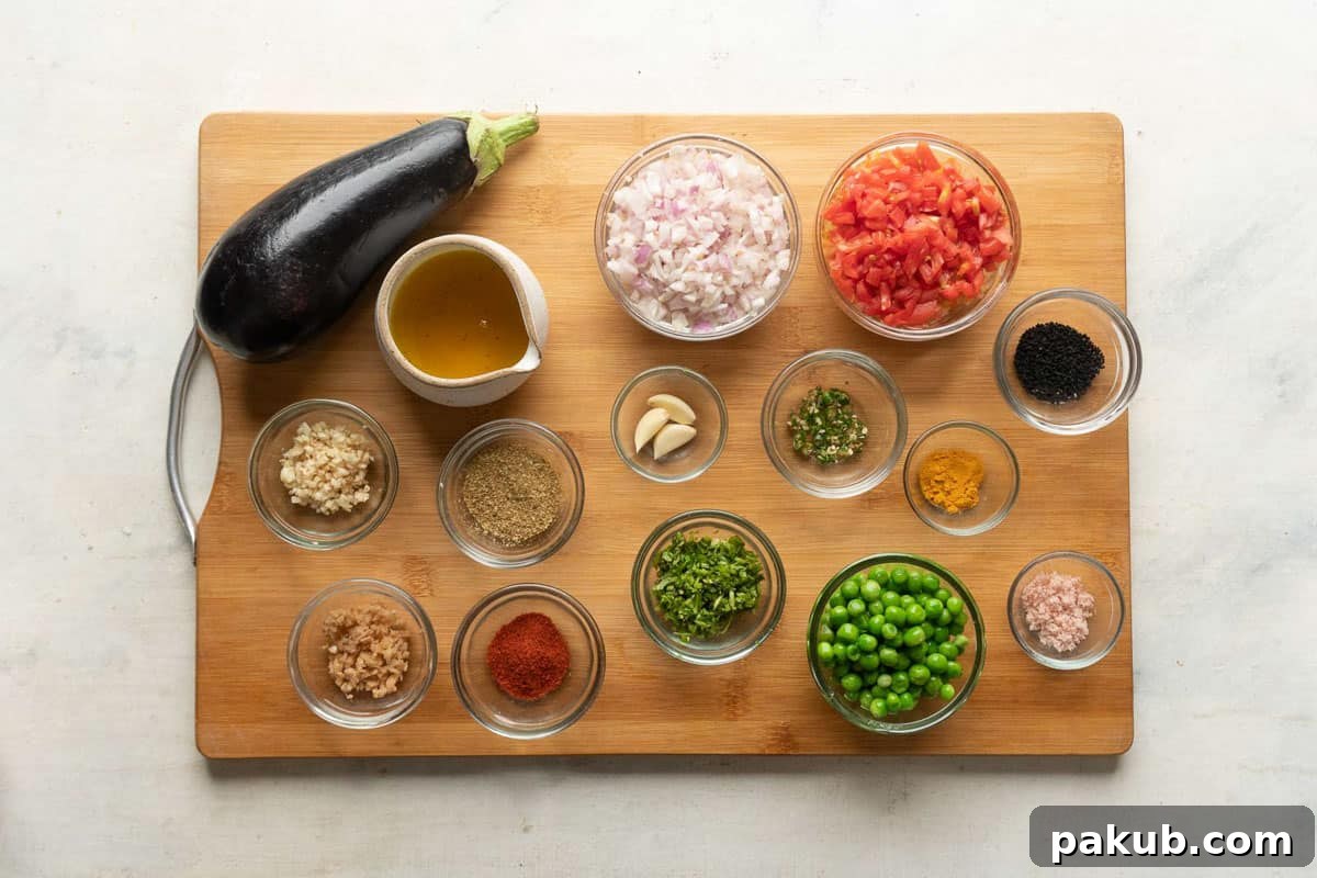 A beautiful flat lay of fresh ingredients laid out on a rustic wooden board, essential for Baingan Bharta. Includes a large eggplant, ripe tomatoes, onions, garlic, ginger, green chilies, and a selection of colorful Indian spices.