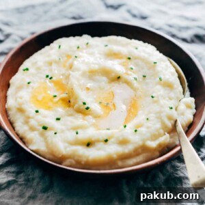 Mashed potatoes flavored with garlic and served in a wooden bowl.