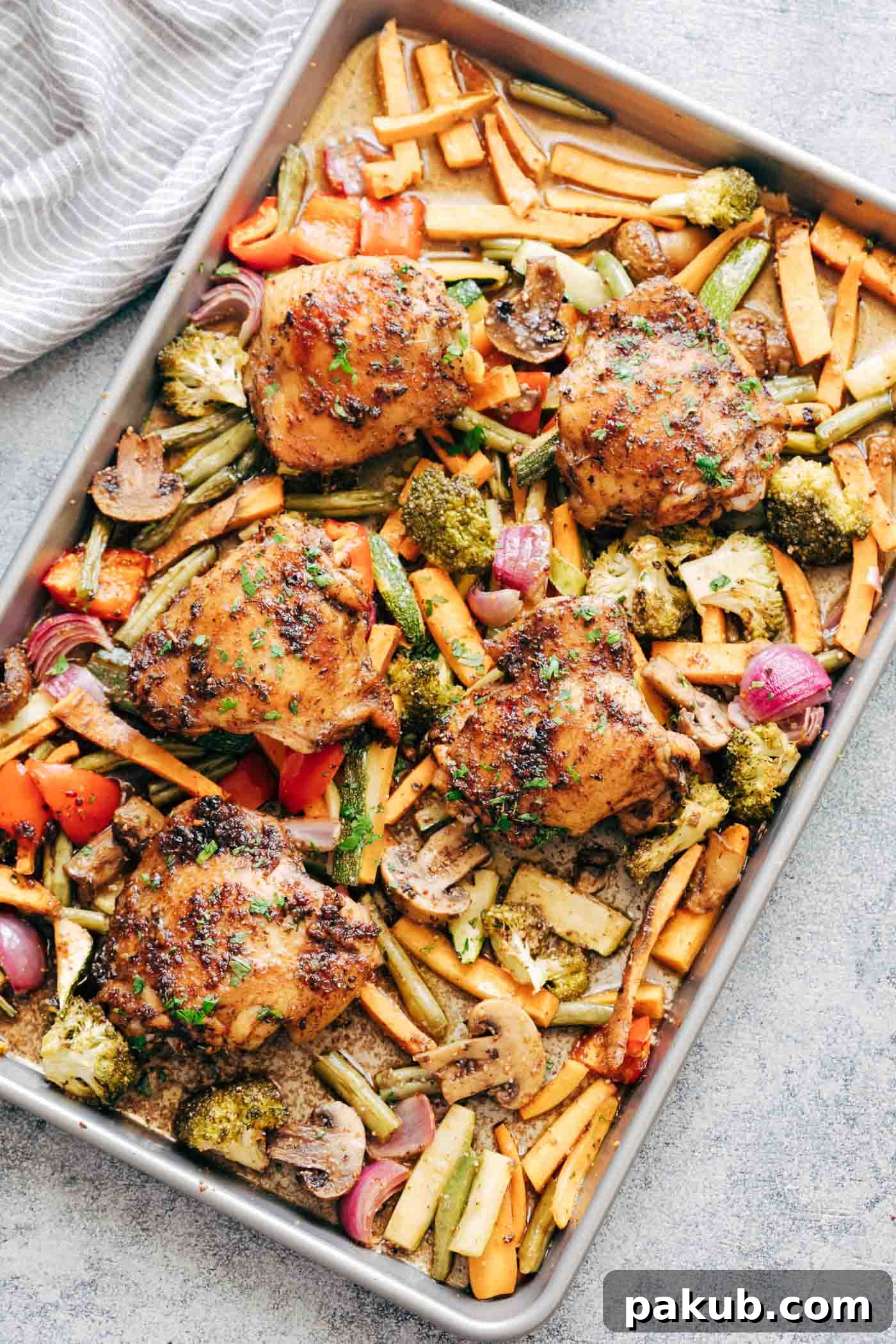 Sheet Pan Honey Balsamic Chicken Thighs with Veggies tray with broccoli, peppers, onions, sweet potatoes, carrots, mushrooms and broccoli