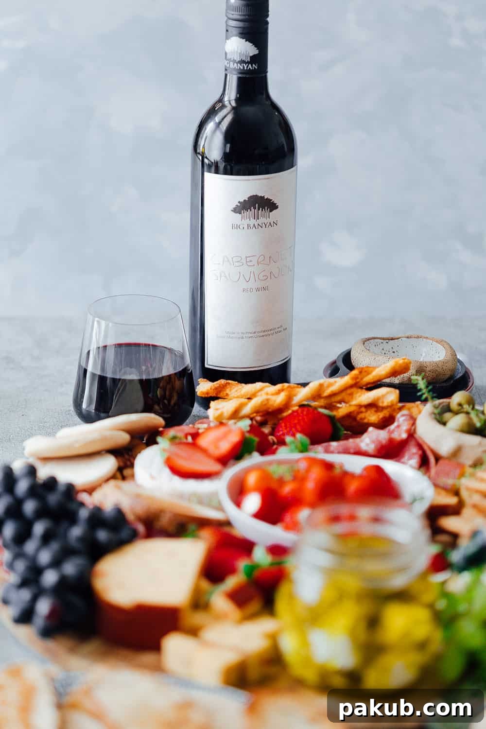 Building an Exquisite Wine and Cheese Board Without Overspending 10 The ultimate wine and cheese board on a budget is not complete with the perfect wines. Pictured here is a cabernet sauvignon with the cheese platter