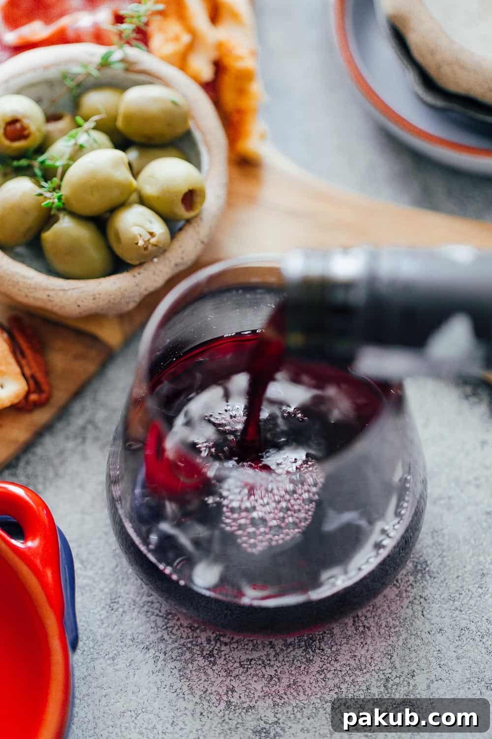 Building an Exquisite Wine and Cheese Board Without Overspending 11 Pouring wine for the ultimate wine and cheese board on a budget