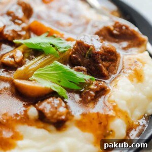 Easy Instant Pot Beef Stew served with mashed potatoes.