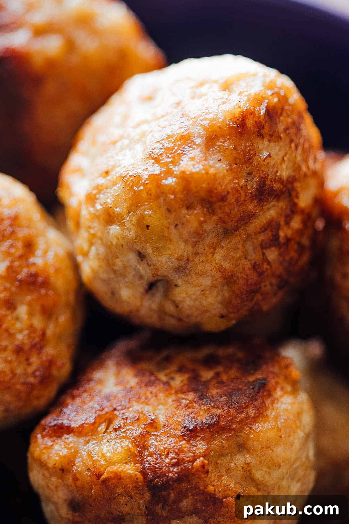 Juicy chicken meatballs being prepared for creamy chicken meatballs in mushroom sauce