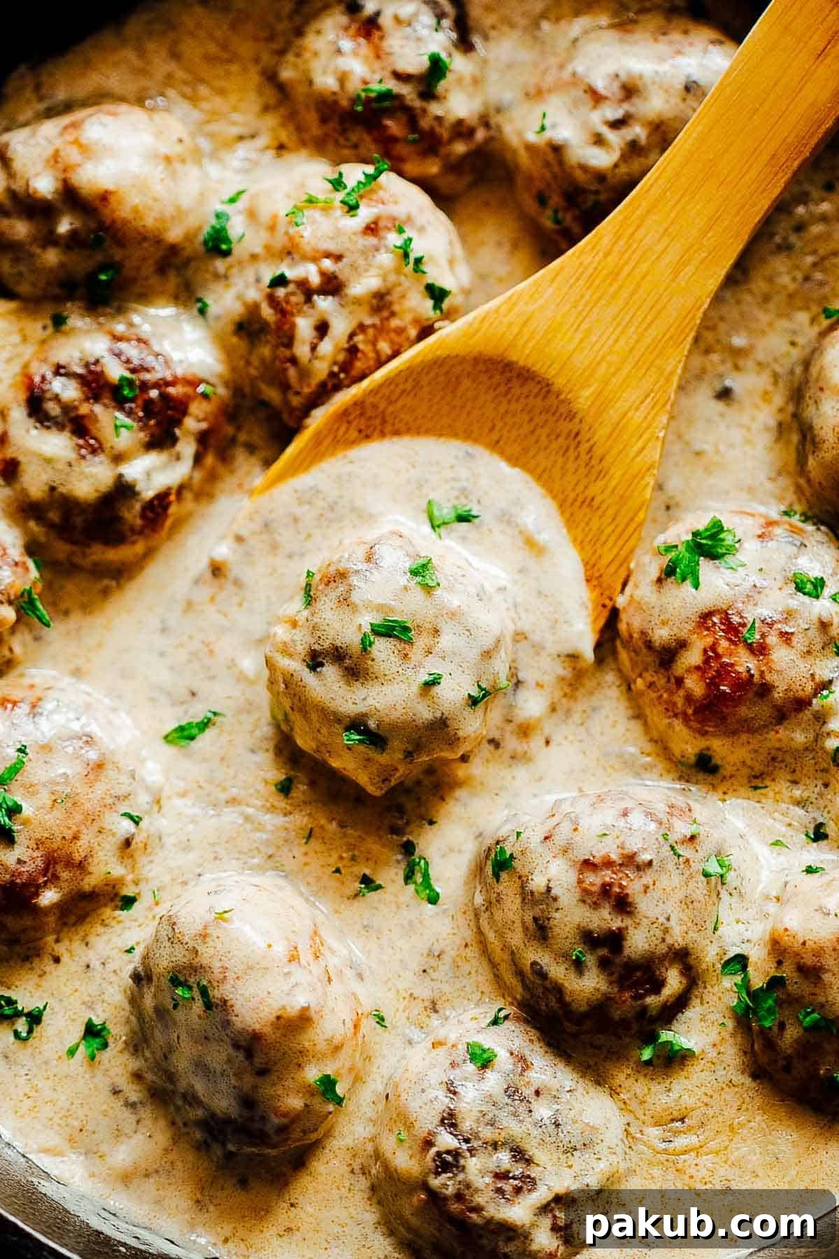 Closeup of creamy chicken meatballs in mushroom sauce, showcasing the rich texture
