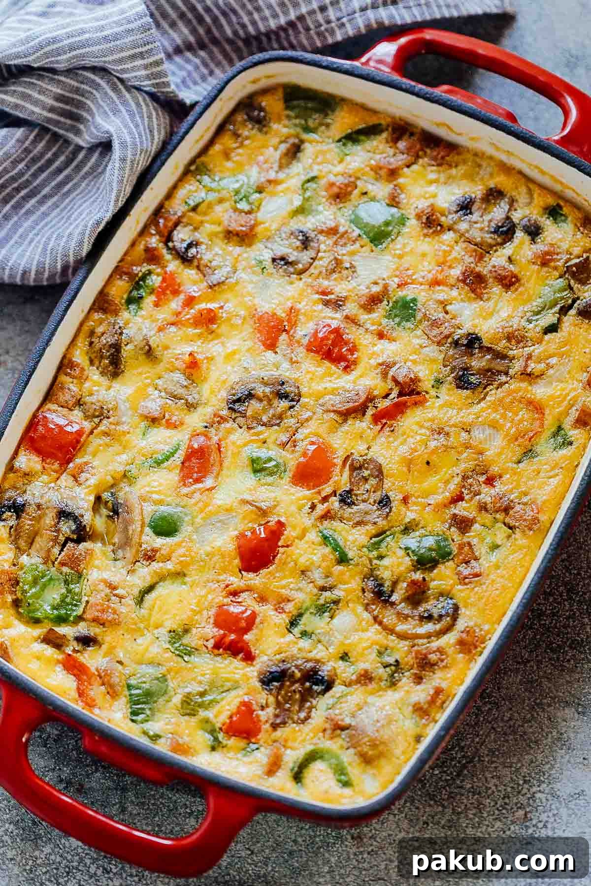 Denver Breakfast Bake 2 Golden brown Baked Denver Omelet Breakfast Casserole in a baking dish fresh out of the oven, ready to be served