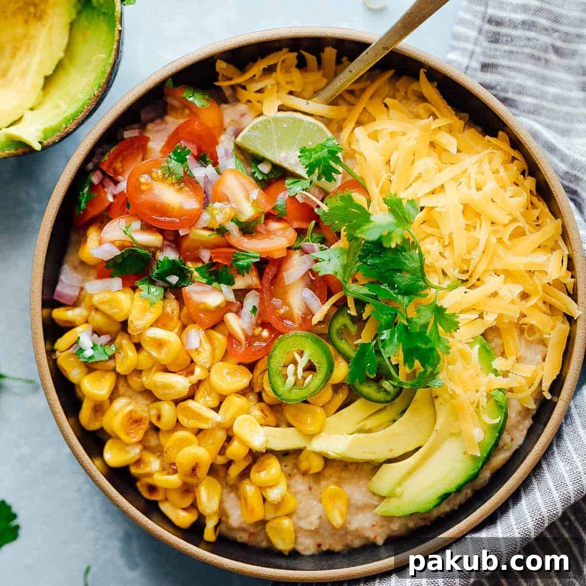 Denver Breakfast Bake 9 A vibrant Mexican oatmeal bowl loaded with savory spices, topped with fresh corn, avocado, salsa, and cheese, presenting a healthy and flavorful breakfast option