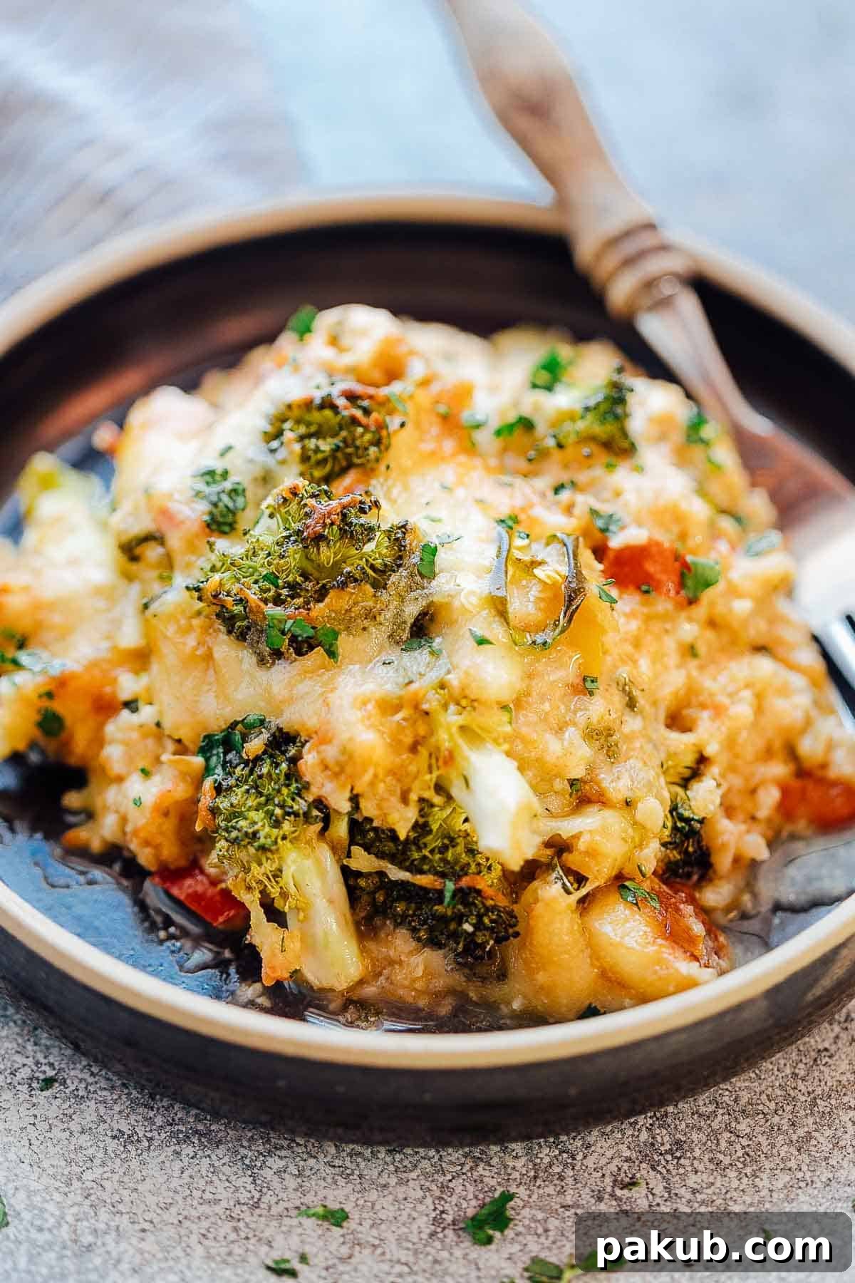 Wholesome Cauliflower Broccoli Bake 4 Healthy Cauliflower Rice Broccoli Casserole served on a plate with a fork, steaming hot