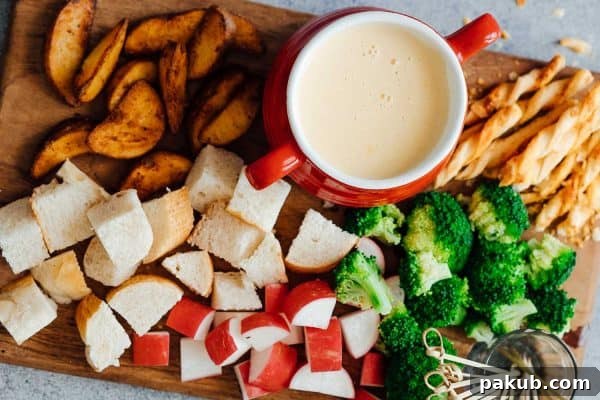 Effortless Pressure Cooker Beef Bourguignon 8 A bubbling pot of easy cheese fondue, surrounded by an array of delectable dippers including crusty bread, fresh broccoli florets, potato wedges, crisp radishes, and pretzel sticks.