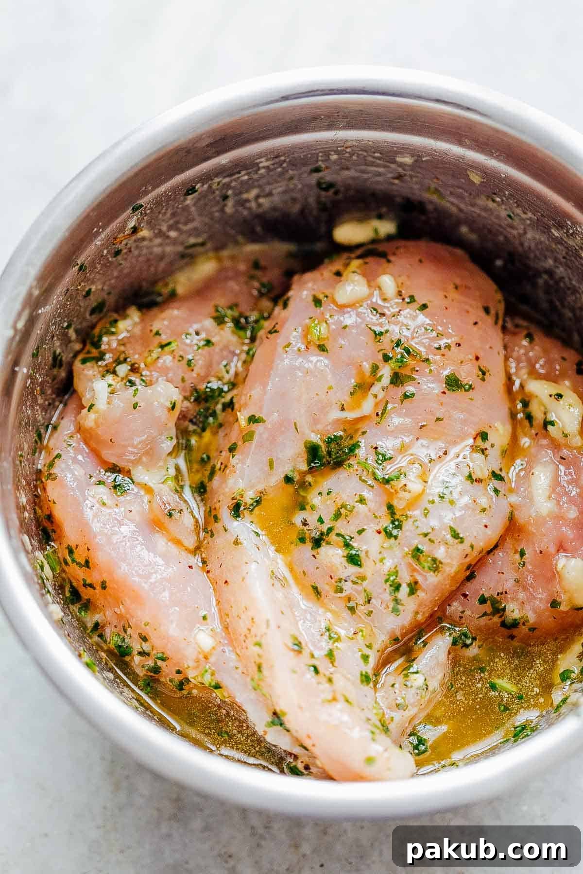 Chicken breasts marinating in cilantro lime vinaigrette, ready for grilling.