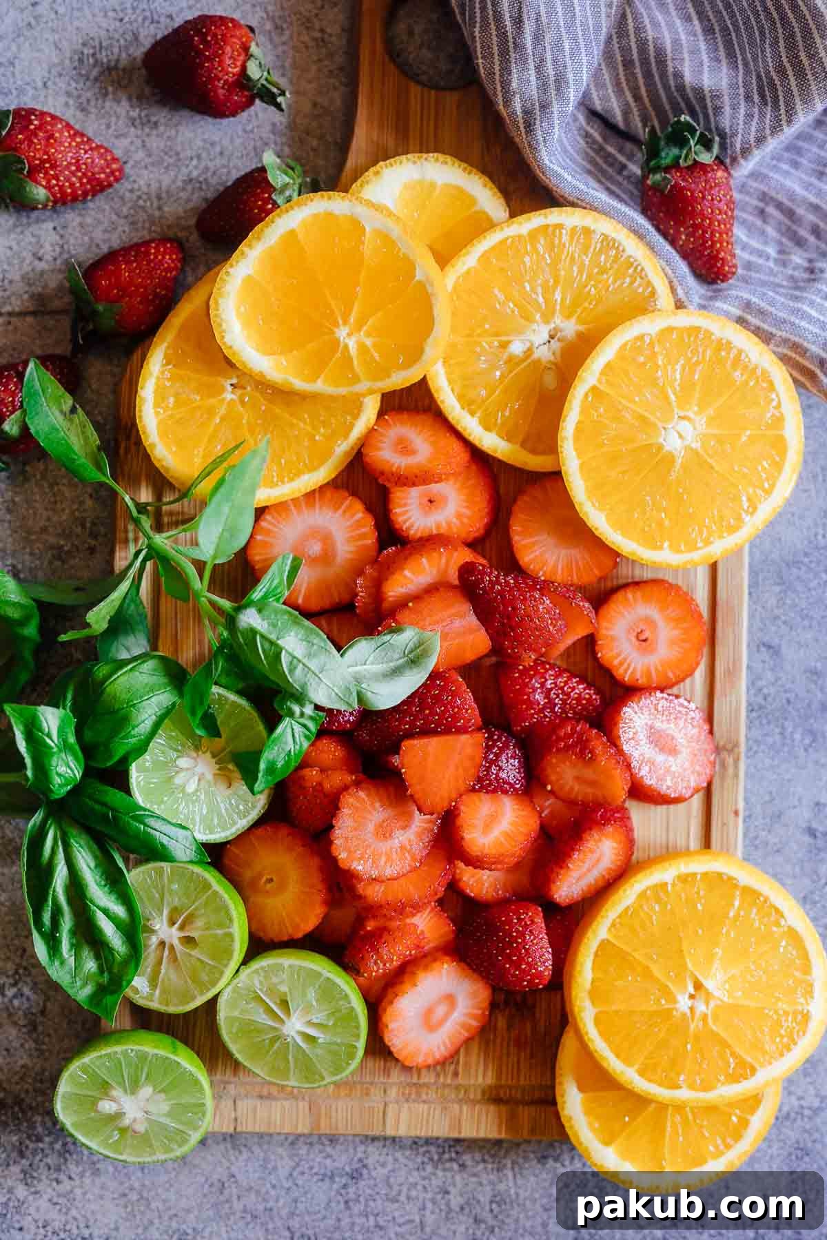 Cut fruits for strawberry orange white wine sangria including strawberries, oranges, and limes