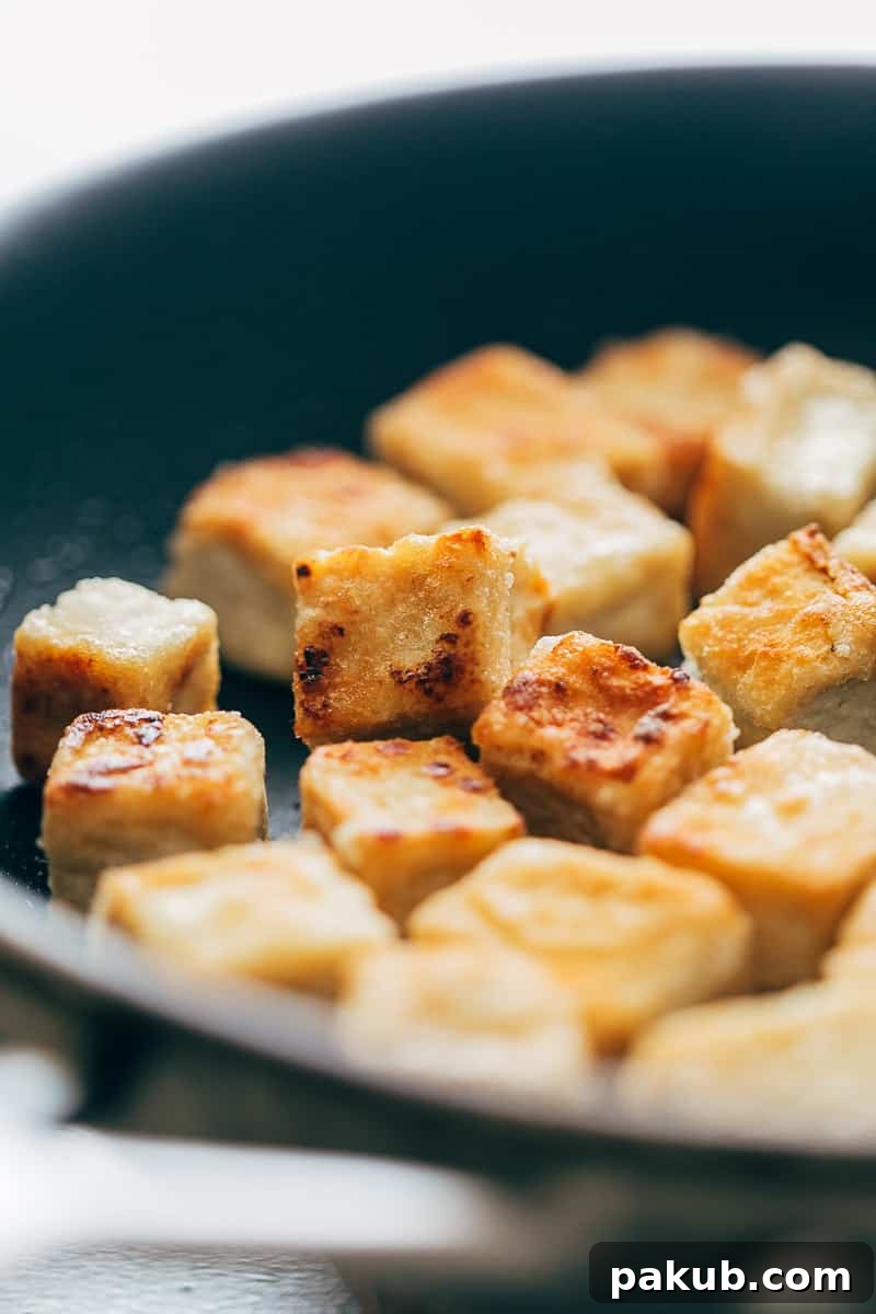 Crispy tofu panfried in a non stick pan till golden brown on all sides