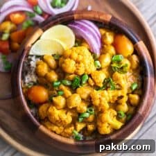 Wholesome Cauliflower Chickpea Coconut Curry served in a beautiful bowl, indicating a complete and satisfying meal for healthy eating.