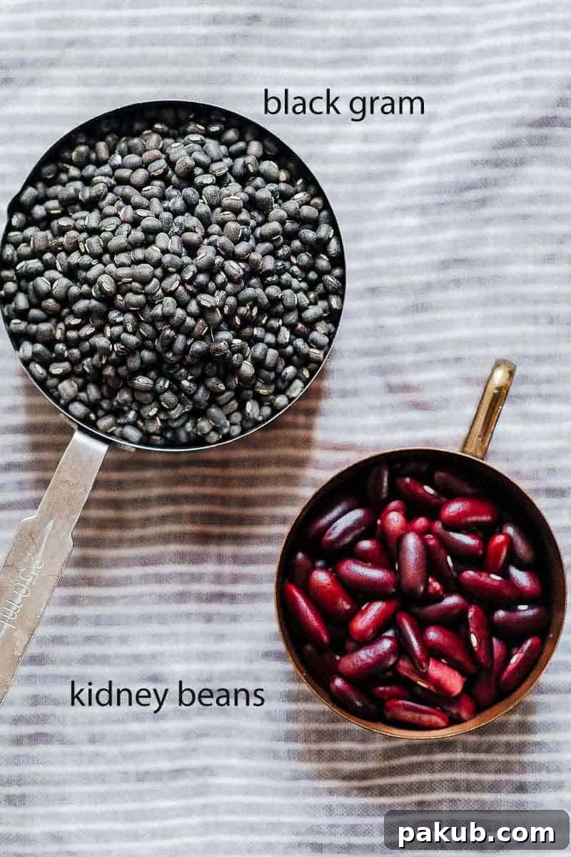 Dal Makhani Mastery Stovetop Pressure Cooker Instant Pot 4 Whole black gram (urad dal) and kidney beans (rajma) displayed separately in measuring cups, emphasizing the two critical lentils required for a traditional Dal Makhani.