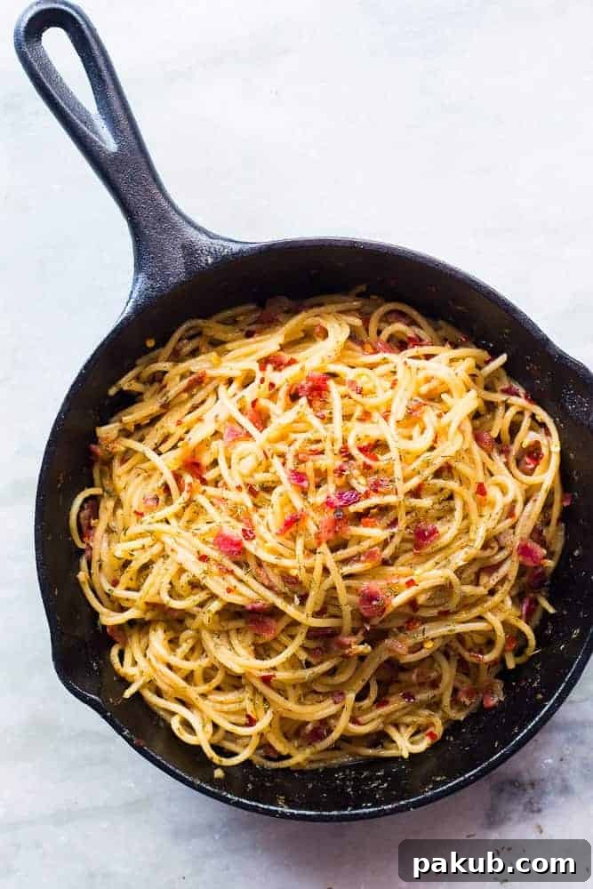 15 Bacon Creations to Make Every Meal a Party 8 An inviting bowl of smoky, spicy, and incredibly easy 5-ingredient Bacon Spaghetti Aglio Olio, showcasing perfectly cooked pasta intertwined with crispy bacon and fragrant garlic. A perfect dish for bacon enthusiasts.