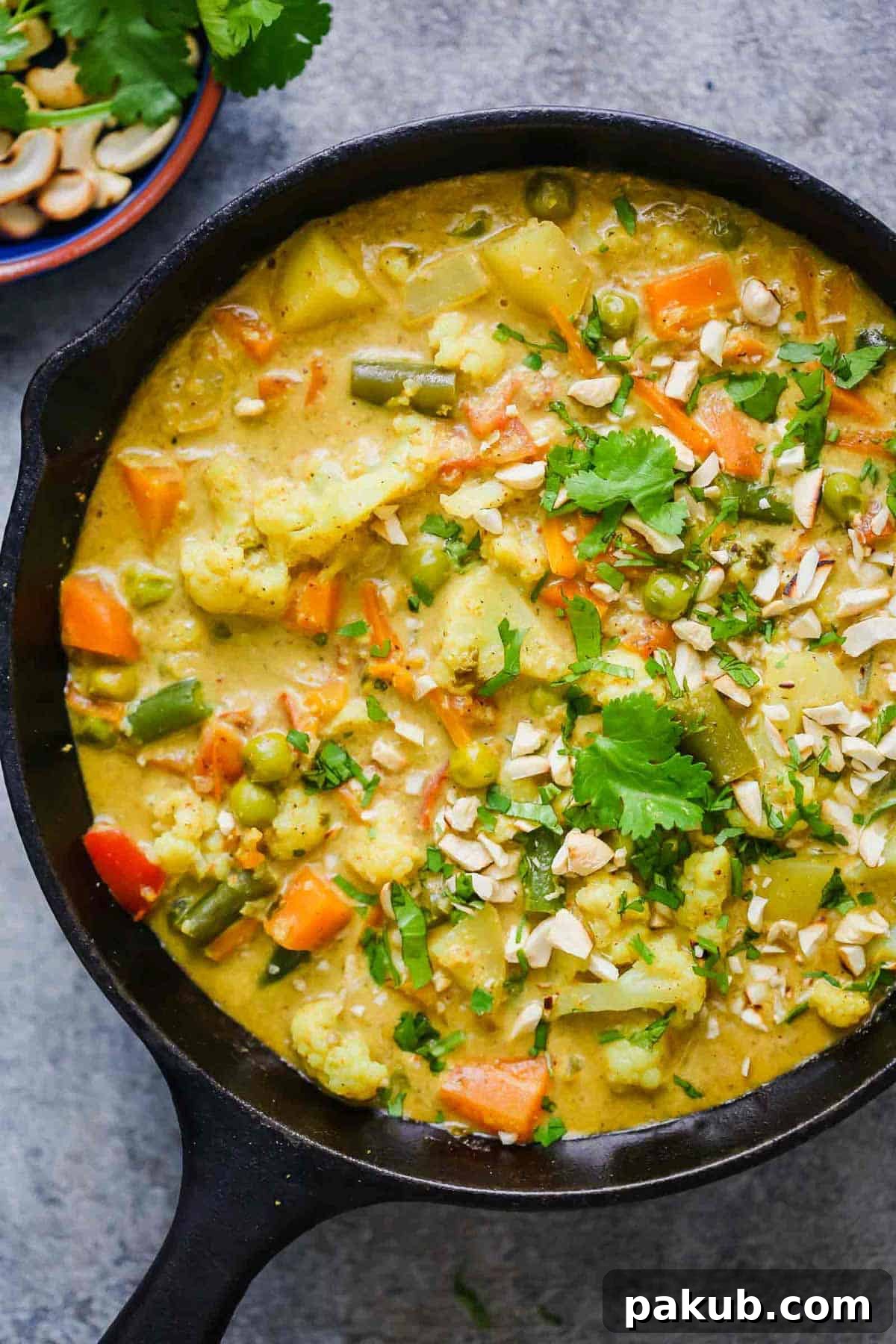 Creamy Vegetable Korma Perfection 2 Rich and creamy Vegetable Korma Curry straight from the stove, served in a rustic cast iron pan