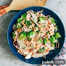 Creamy Apple Broccoli Walnut Salad served in a blue bowl.