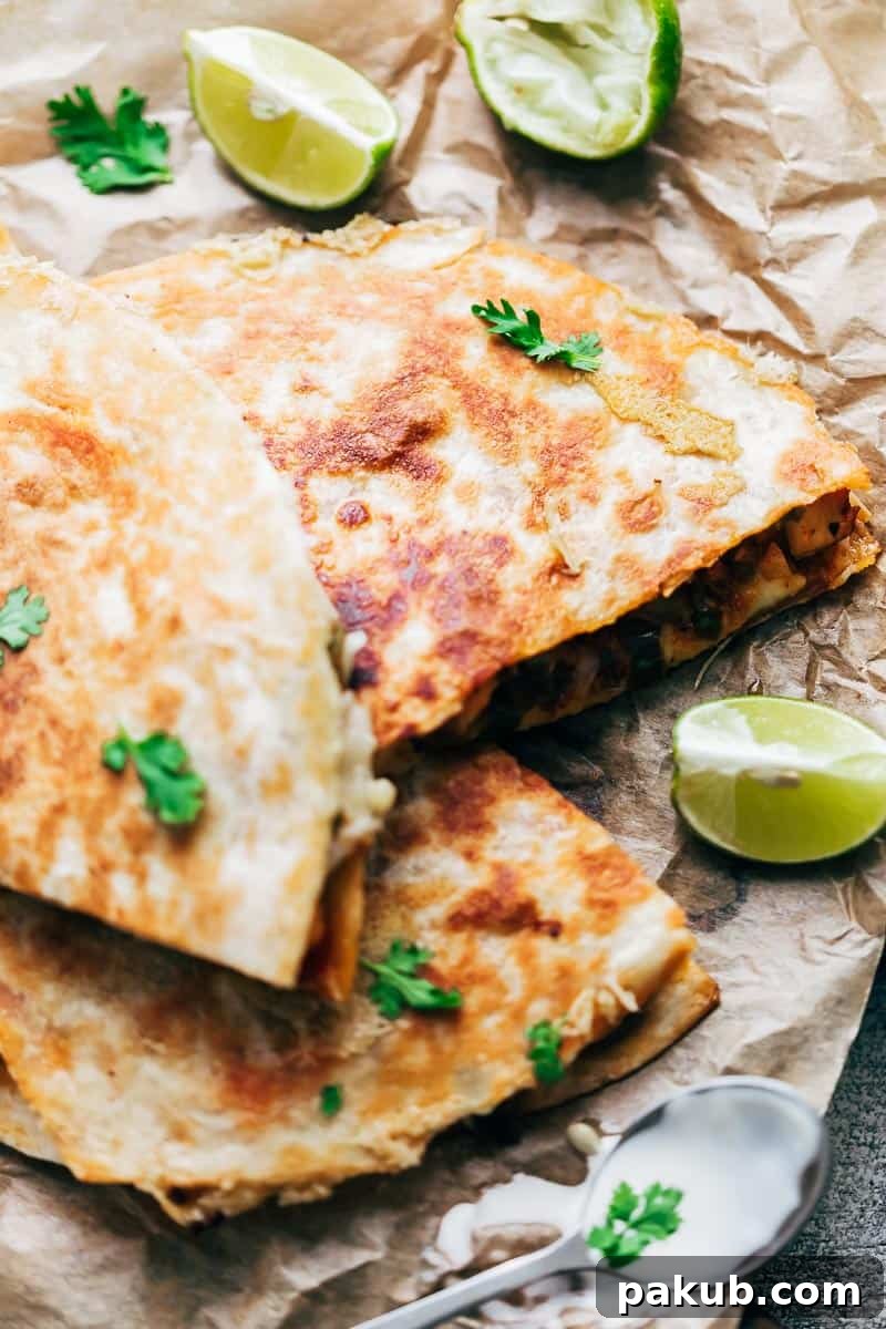 Effortless Chicken Fajita Quesadillas 4 Closeup shot of a perfectly cooked chicken fajita quesadilla, showcasing the golden-brown, crispy tortilla and irresistible bits of melted cheese that have caramelized onto the surface, creating an extra layer of flavor and crunch