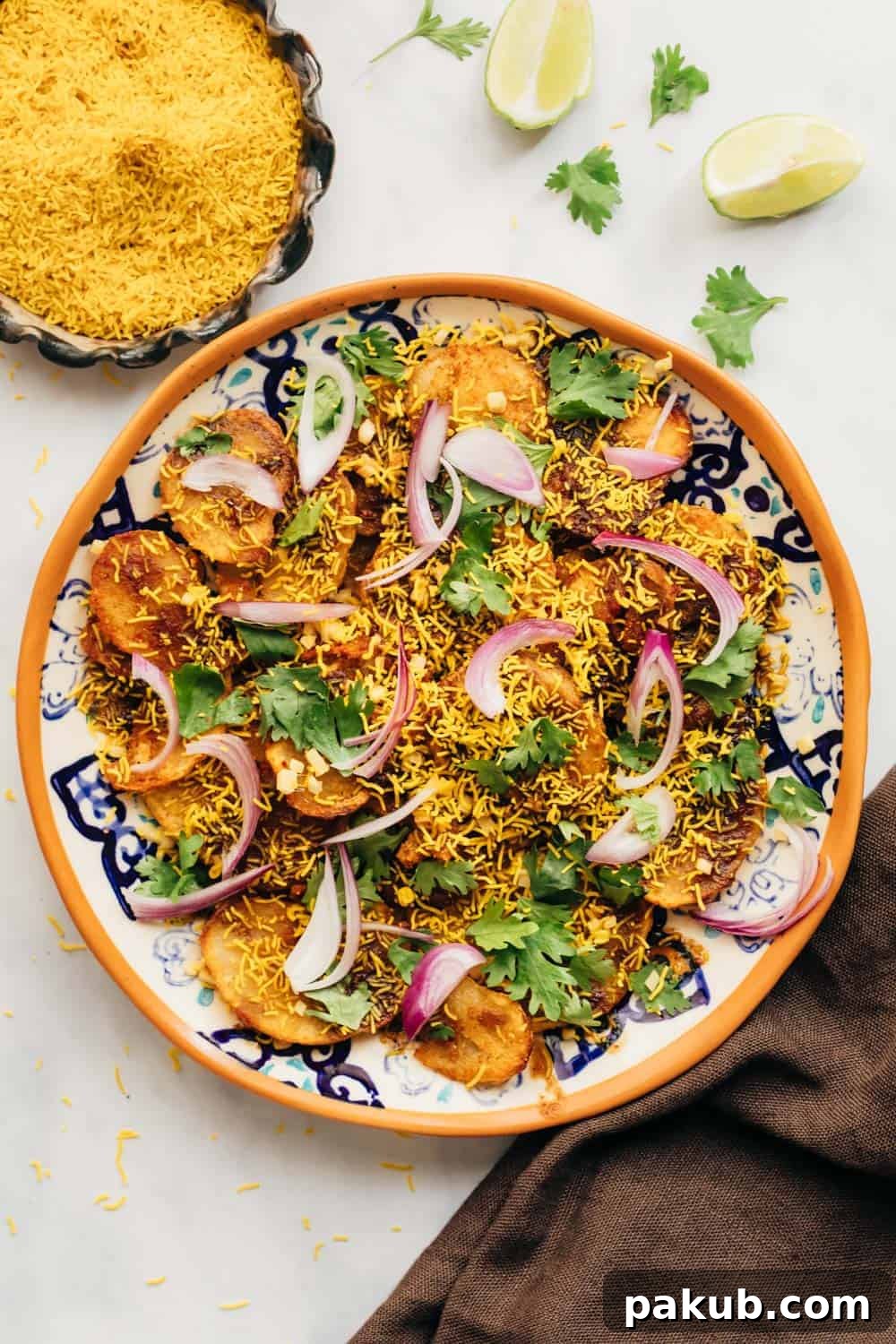 Simple Delhi Aloo Chaat 2 Easy Aloo Chaat - Delhi style served on a plate with sev on the side, showcasing beautifully golden and crispy potatoes