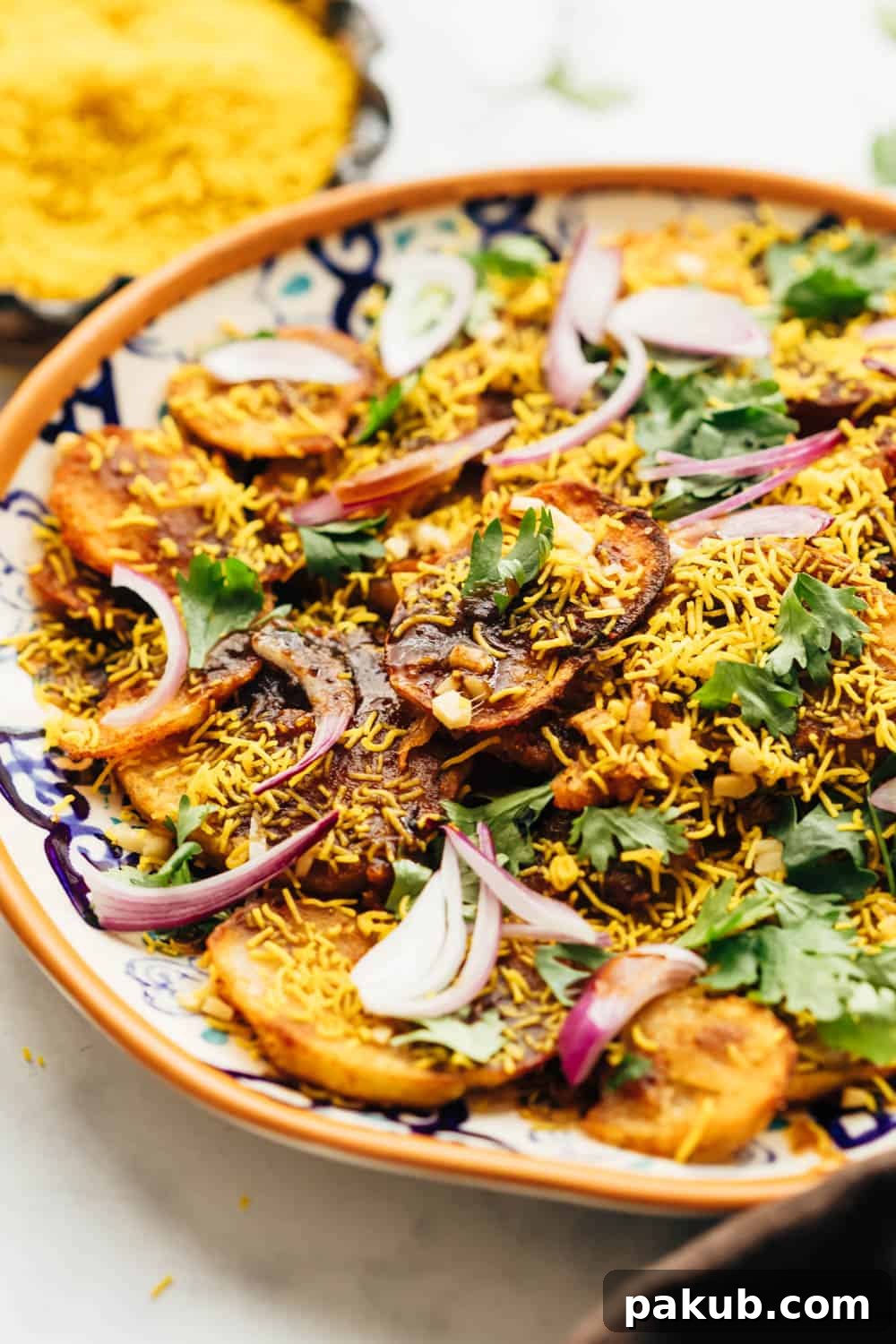 Simple Delhi Aloo Chaat 3 Closeup of easy Aloo Chaat - Delhi style served on a plate with sev and lime on the side, highlighting the layered textures and fresh garnishes