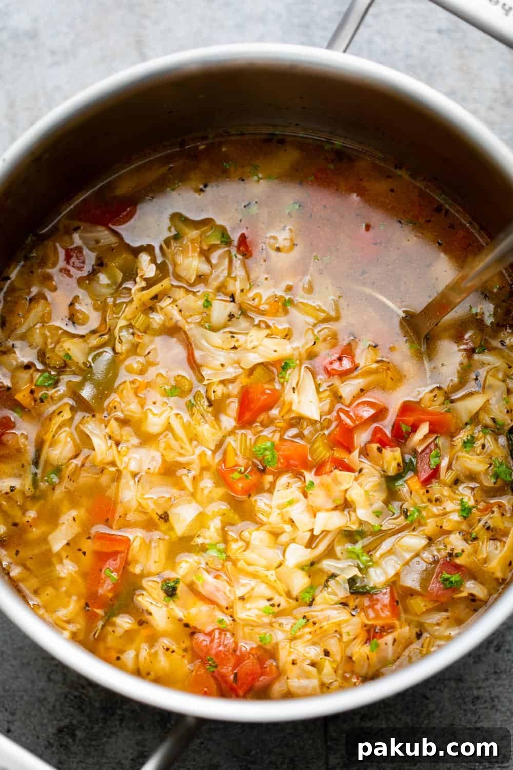 Cabbage Soup Reset 4 A large pot of detox cabbage soup simmering on the stovetop, showcasing the abundant vegetables.