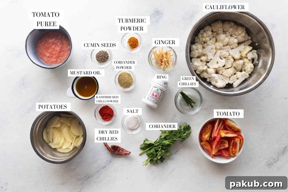 Picture of all the ingredients for aloo gobi masala with text to identify them