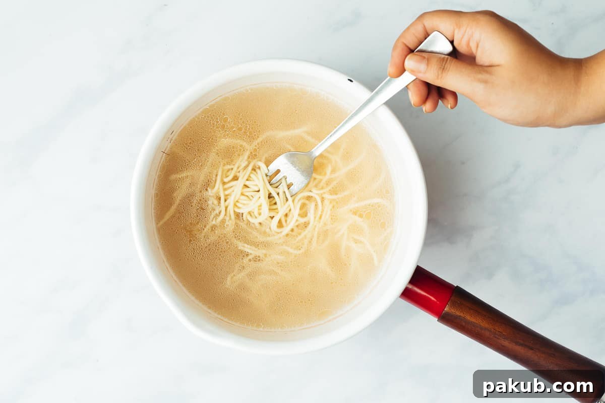 Noodles perfectly boiled to an al dente texture in salted water, prepared for crispy fried noodles recipe