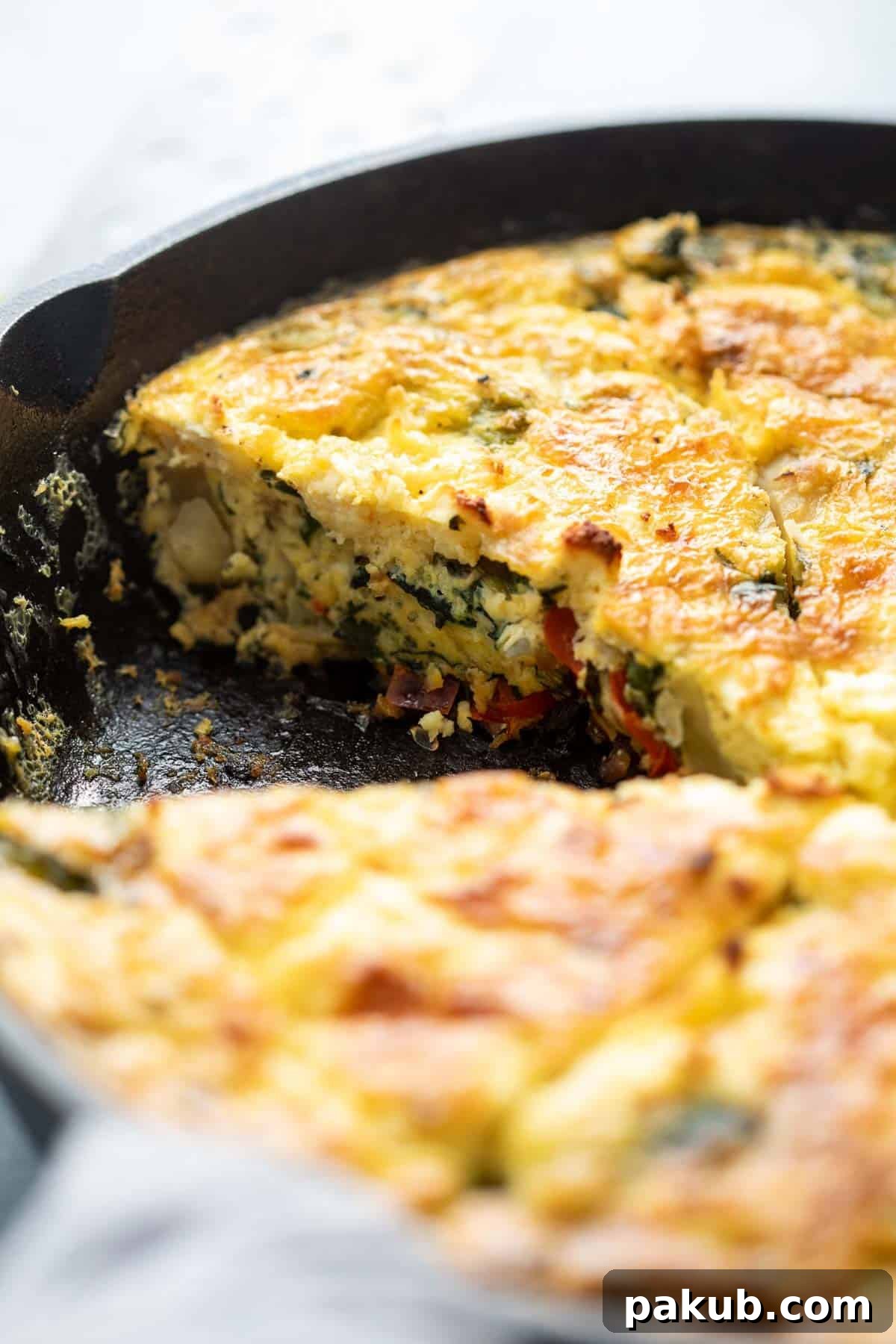 Rustic Cast Iron Spinach Potato Frittata 3 A close-up shot of a beautifully cooked Spinach Potato Veggie Frittata, sliced and resting in a rustic cast iron skillet, showcasing its fluffy texture and colorful vegetable medley.