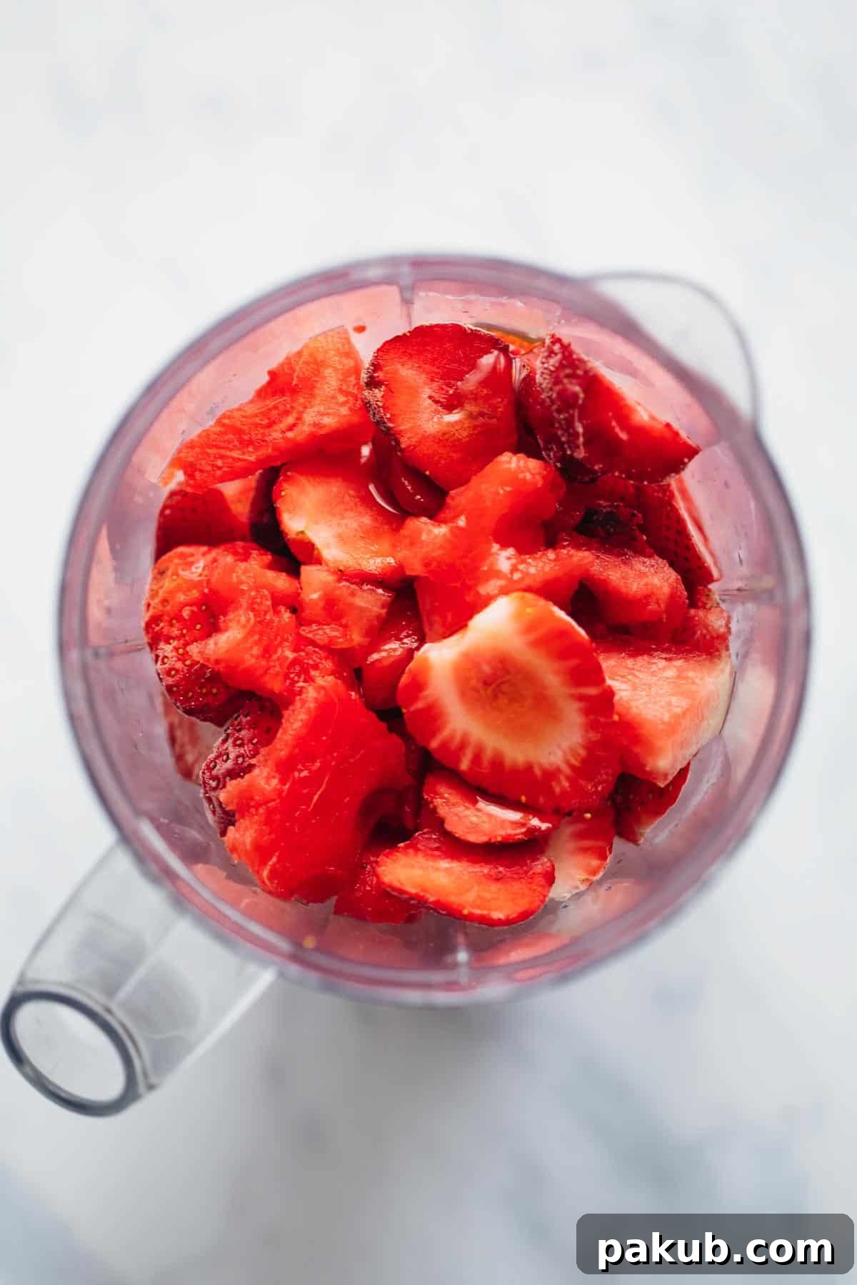 Velvet Watermelon Lime Chill 3 Fresh watermelon cubes, frozen strawberries, lime juice, and honey in a blender cup, ready to be blended into a smoothie.