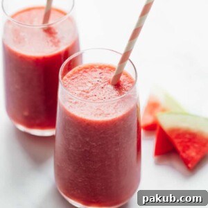 Two glasses of watermelon lime smoothie with paper straws
