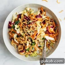 Crunchy Chinese chicken salad served in a bowl with a fork