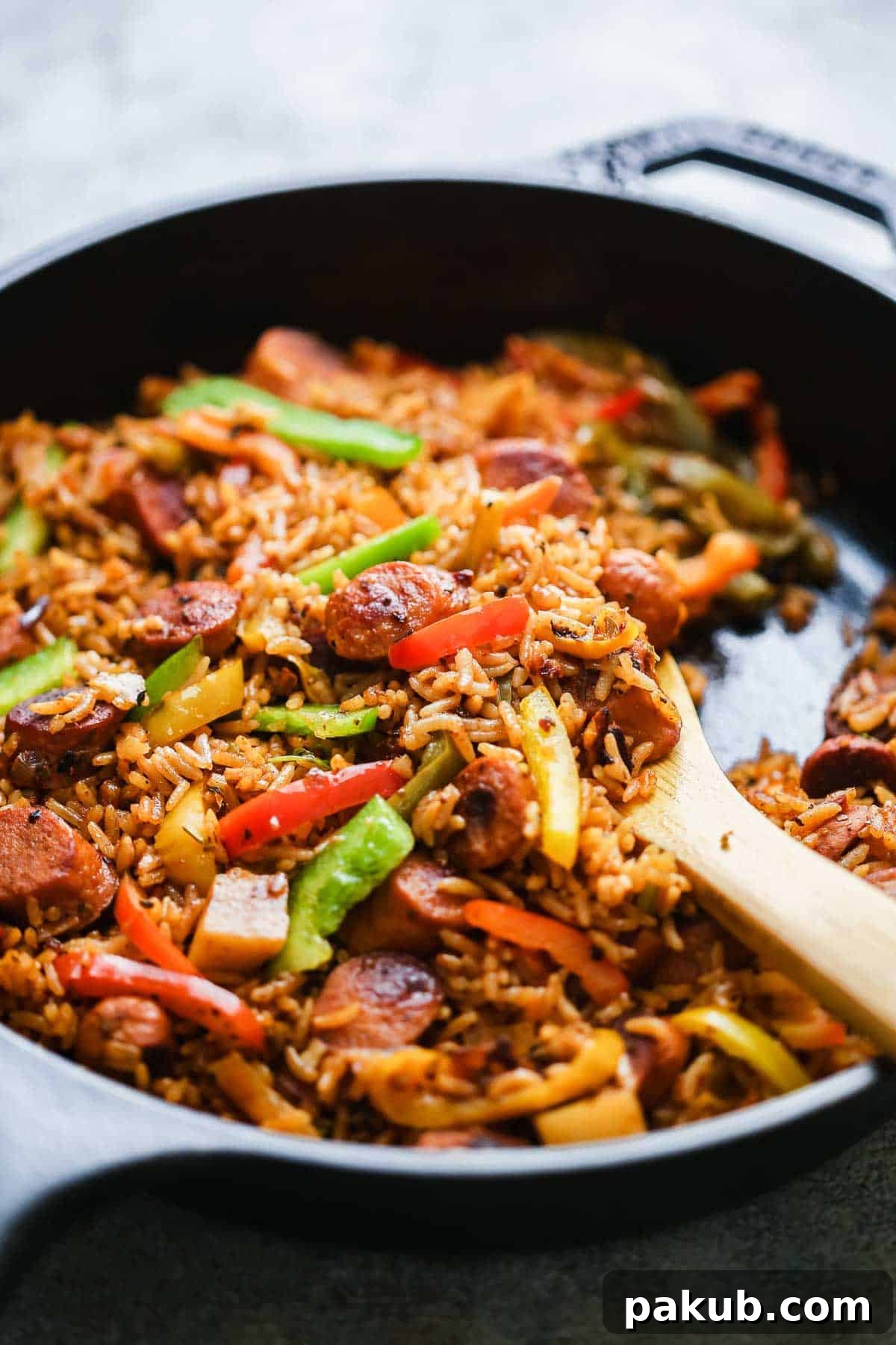 Close-up of One Pot Mexican Rice and Sausages in a cast iron pan, showing texture and ingredients