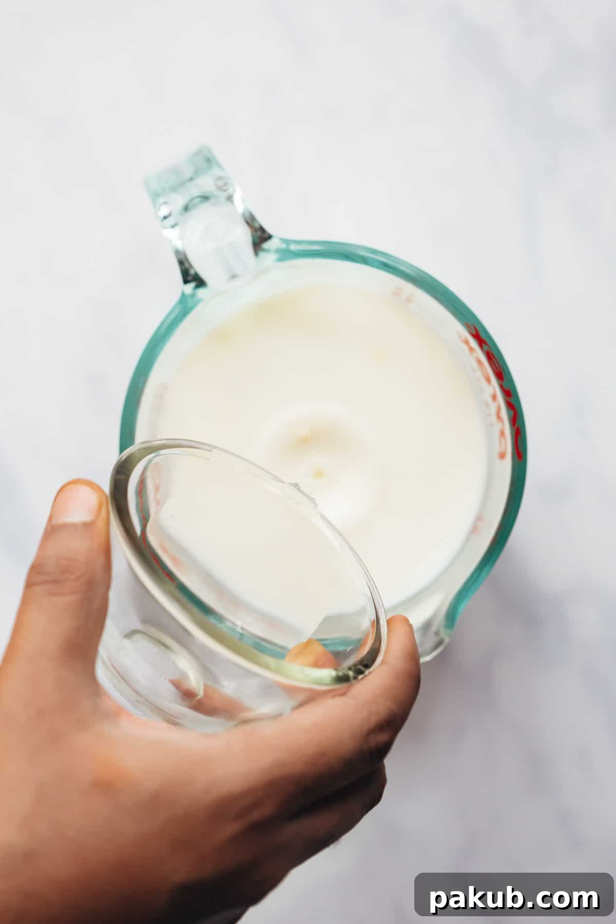 Adding vinegar to milk for making buttermilk.