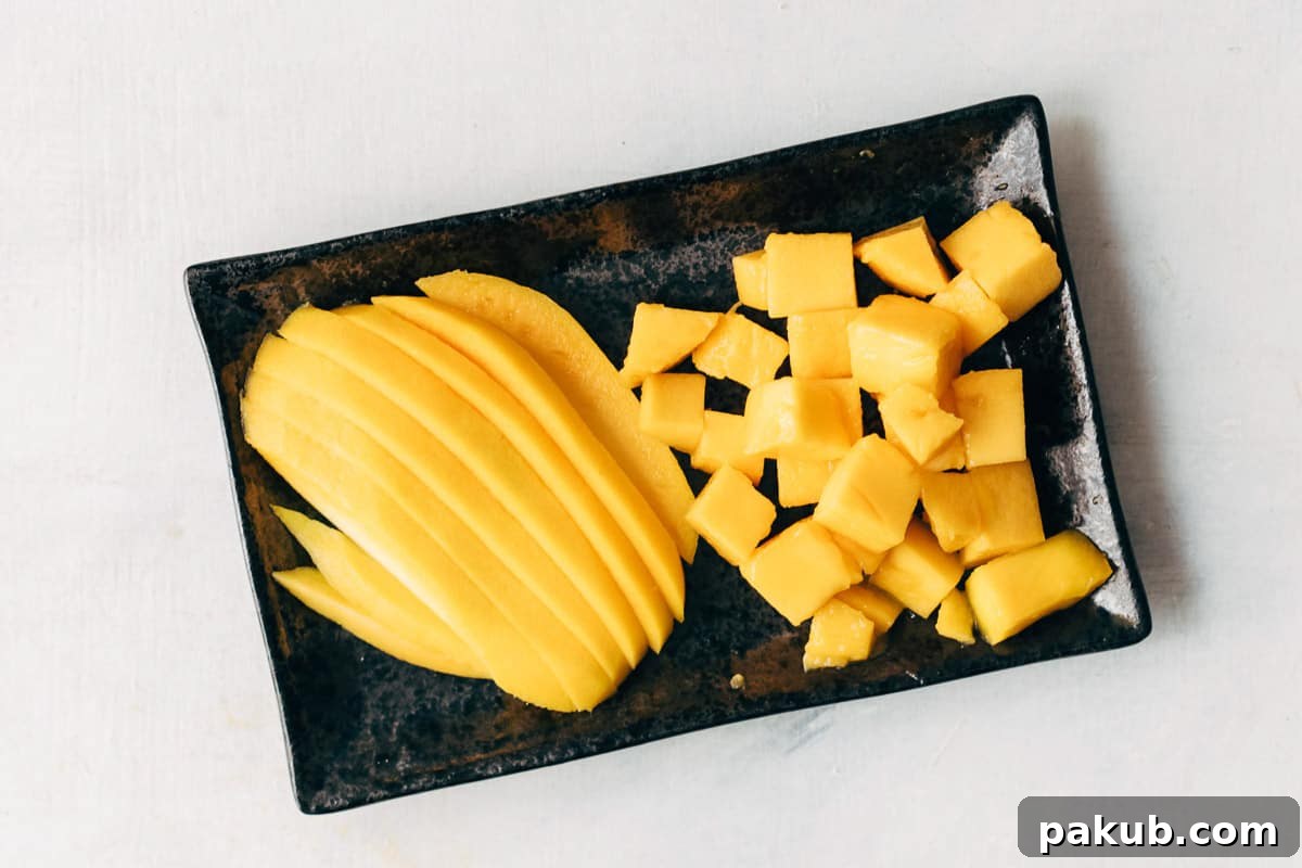 Easy Step-by-Step Guide to Cutting a Mango 13 An assortment of finely cut mango pieces, including thin wedges and neat dices, showcasing the versatility of cutting a peeled mango.
