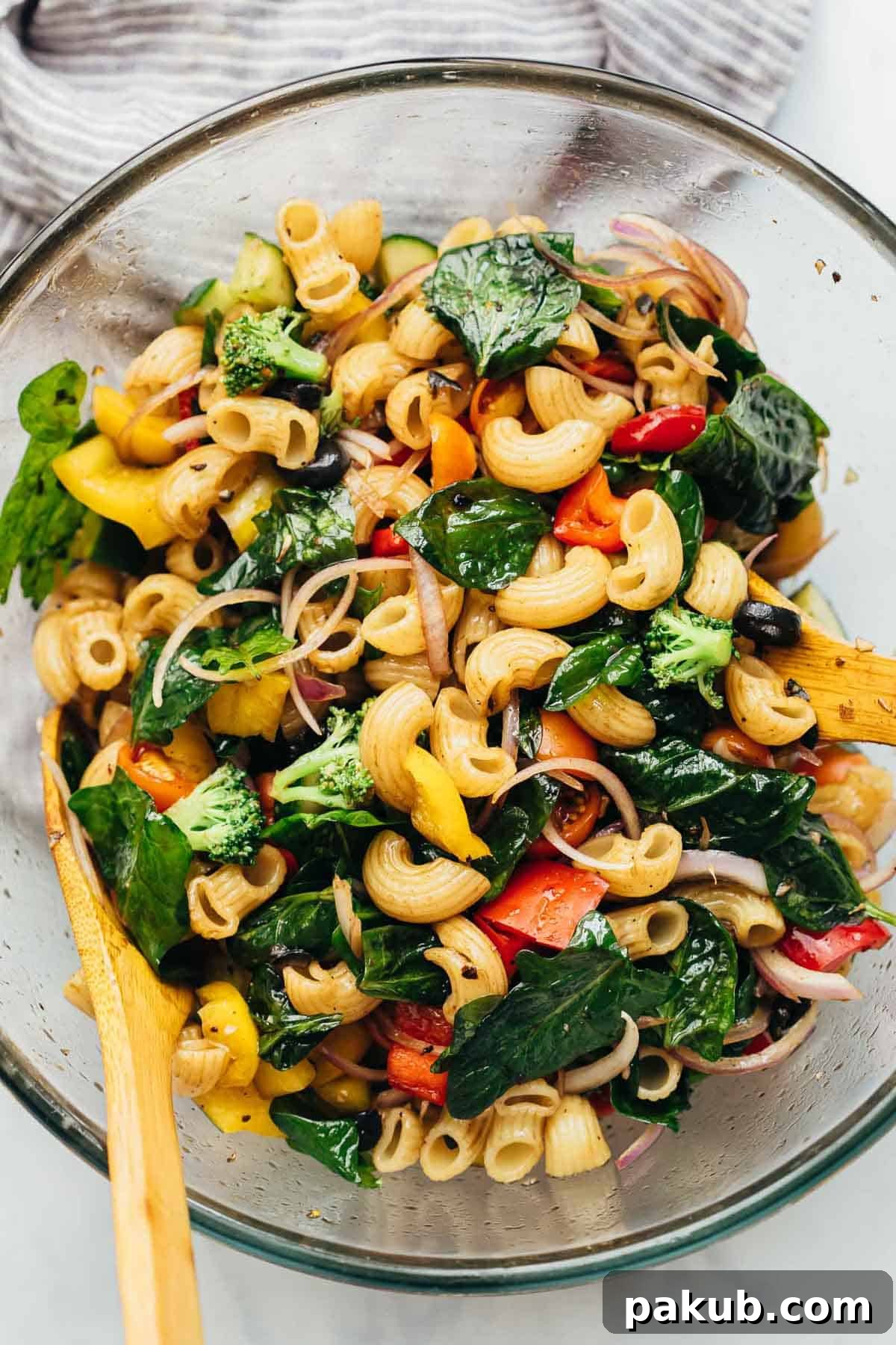 Vibrant Vegan Pasta Salad tossed in a large mixing bowl, ready to be served and enjoyed by everyone.