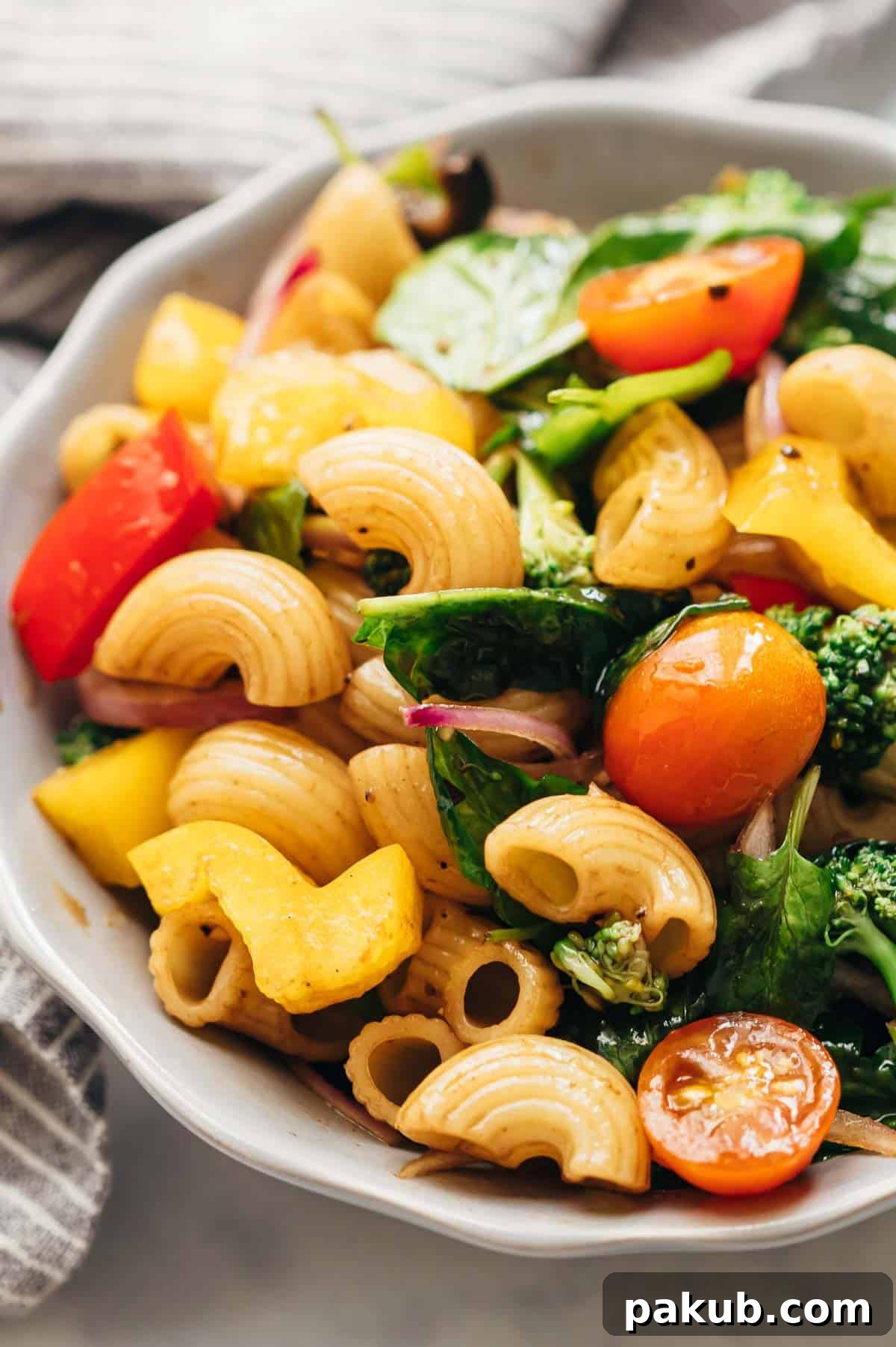 Close-up of Vegan Pasta Salad with Italian Balsamic Dressing served in a elegant bowl, showcasing the fresh ingredients.