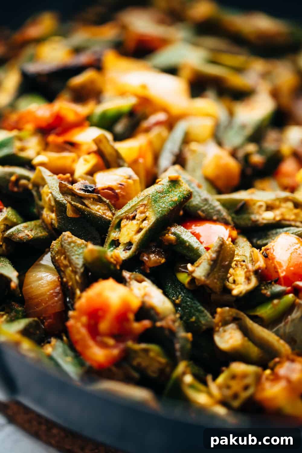 Effortless Spiced Okra Stir Fry 4 Close-up view of Bhindi Masala in a wok, showing the rich, dry curry coating on each okra piece, ready to be transferred to a serving dish.