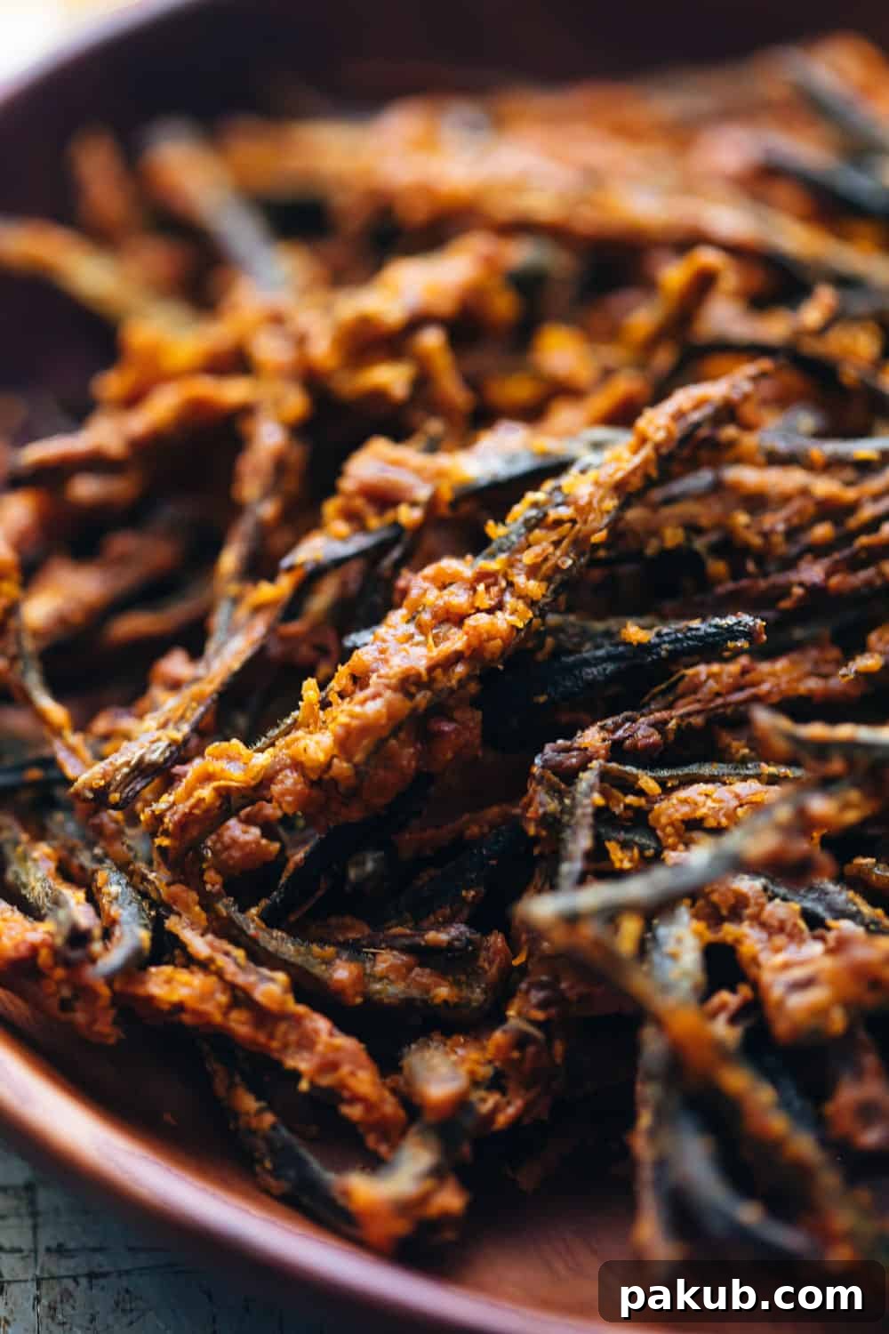 Golden Baked Okra Crisps 4 A captivating close-up of baked kurkuri bhindi, showcasing its detailed texture and spice coating.