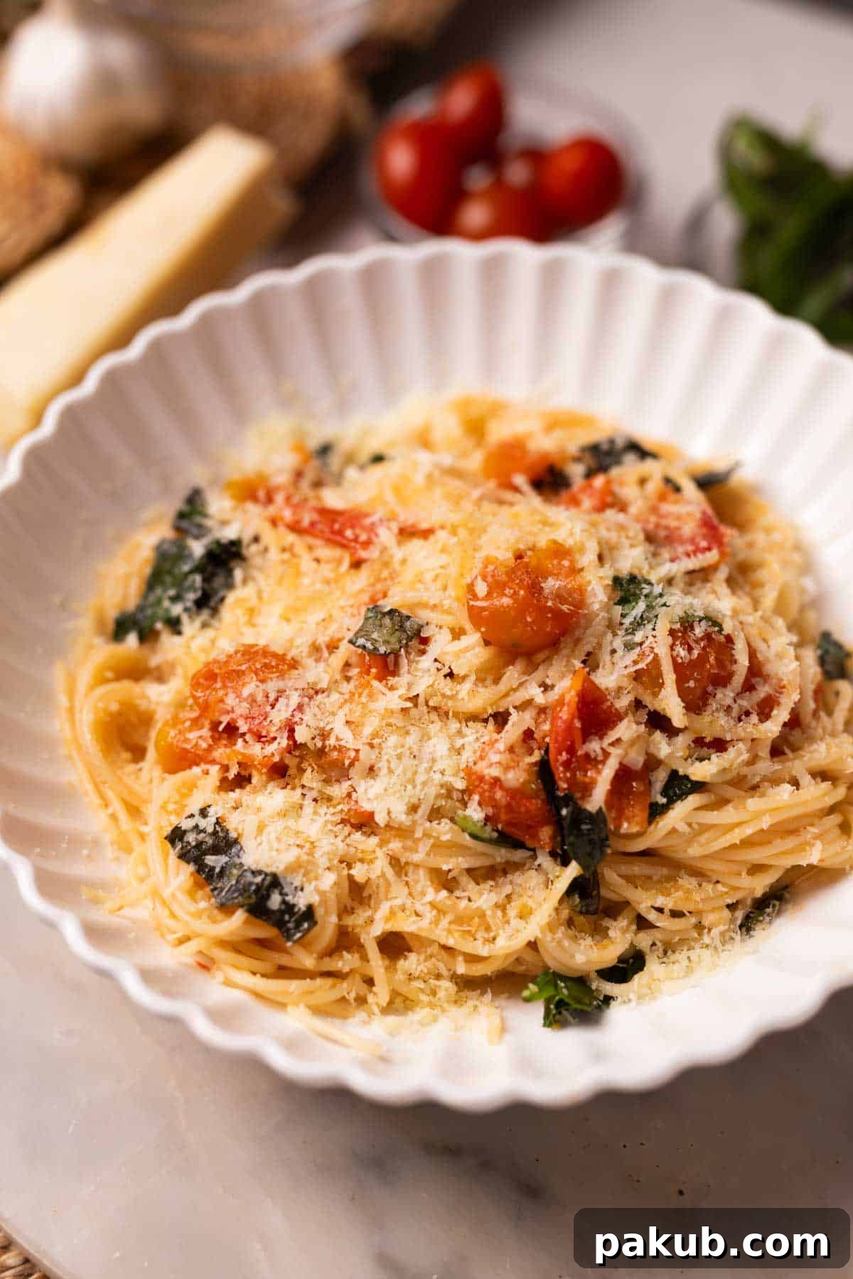 Speedy Tomato Basil Pasta in 15 Minutes 3 Close-up shot of vibrant tomato basil pasta, generously topped with melted mozzarella and fresh basil leaves in a white bowl.