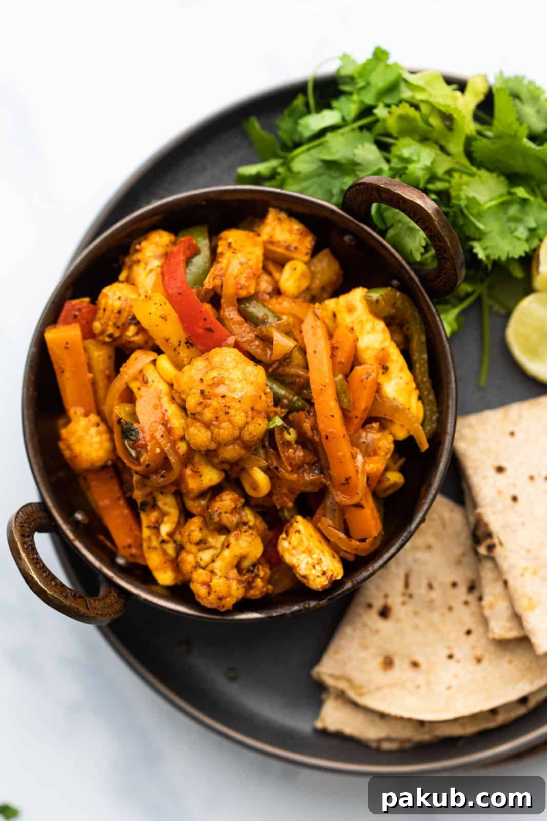 Gourmet Vegetable Jalfrezi Your Favorite Restaurant Dish 2 Flavorful Vegetable Jalfrezi served with freshly made rotis, a perfect Indian vegetarian meal.