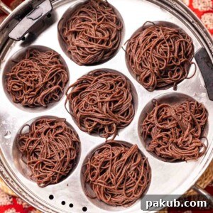 freshly steamed ragi idiyappams placed in a in steamer