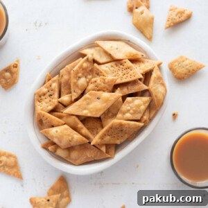 Picture of namak para in a white bowl with cups of chai around it
