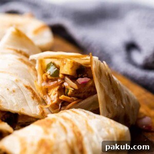 Paneer kathi roll cut into pieces and stacked on top of the other
