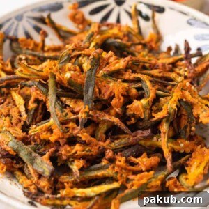 Air fried kurkuri bhindi in a white bowl