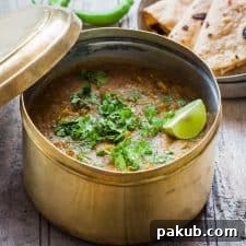 Dhaba Style Dal Fry garnished with lime, coriander and served in a dabba with a side of rotis.