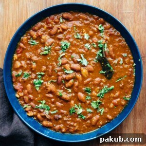 Rajma Masala served in a blue bowl with chopped coriander sprinkled over